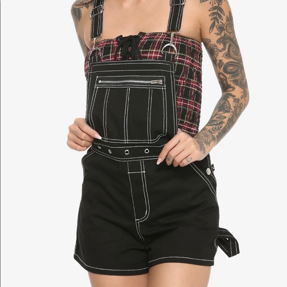 Black overall shorts with white detailing.